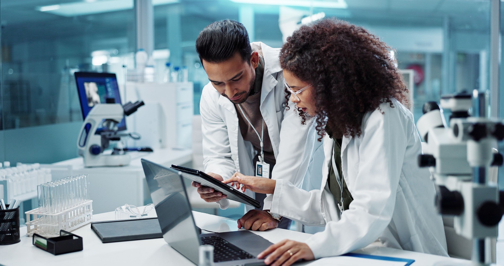 Science, teamwork and scientist with tablet in laboratory for communication, pharmaceutical review or planning. Employees, collaboration and technology for research, discussion and digital analysis